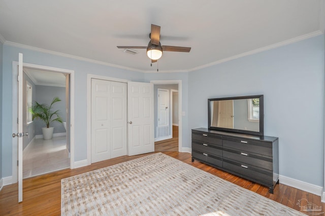 4900 Shell Rd, Milton, FL 32583 - bedroom featuring wood finished floors, baseboards, visible vents, a closet, and crown molding