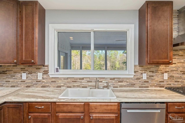4900 Shell Rd, Milton, FL 32583 - kitchen with brown cabinetry, a sink, stainless steel dishwasher, wall chimney exhaust hood, and tasteful backsplash