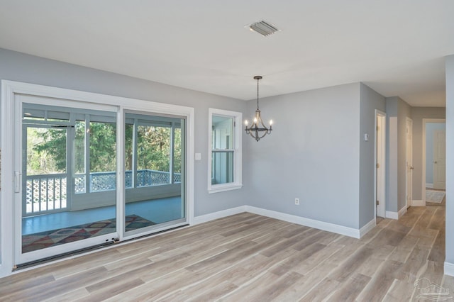 4900 Shell Rd, Milton, FL 32583 - unfurnished dining area featuring an inviting chandelier, visible vents, baseboards, and light wood finished floors