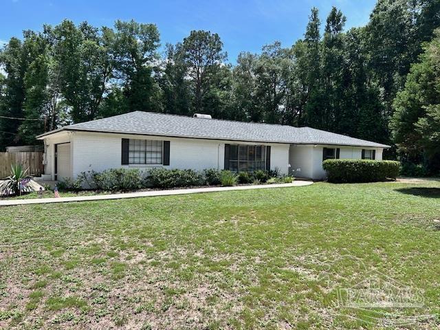 5945 Pamela Dr, Milton, FL 32570 - single story home with a front lawn and a garage