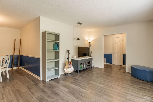 5945 Pamela Dr, Milton, FL 32570 - living area with wood finished floors, baseboards, and a textured ceiling