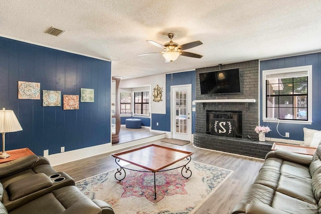 5945 Pamela Dr, Milton, FL 32570 - living area featuring plenty of natural light, baseboards, a textured ceiling, a ceiling fan, and wood finished floors