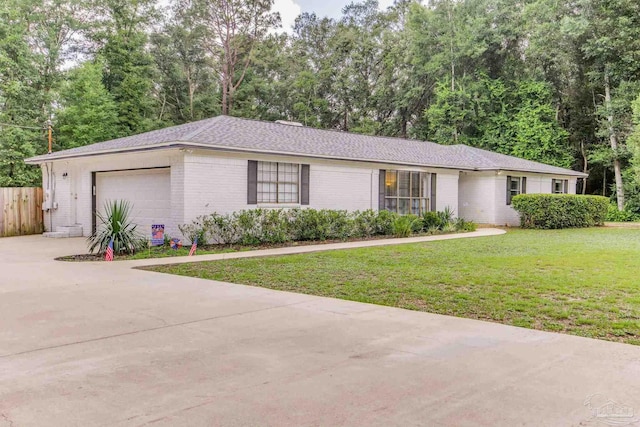 5945 Pamela Dr, Milton, FL 32570 - single story home with concrete driveway, brick siding, and a garage