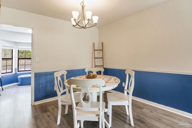 5945 Pamela Dr, Milton, FL 32570 - dining room with wood finished floors, a chandelier, and baseboards