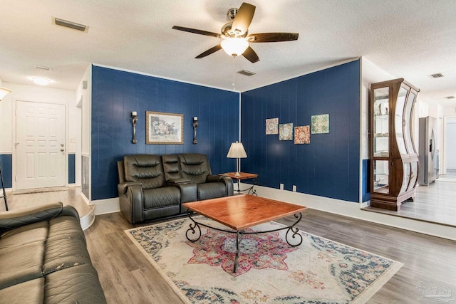 5945 Pamela Dr, Milton, FL 32570 - living area featuring a ceiling fan, baseboards, wood finished floors, and a textured ceiling