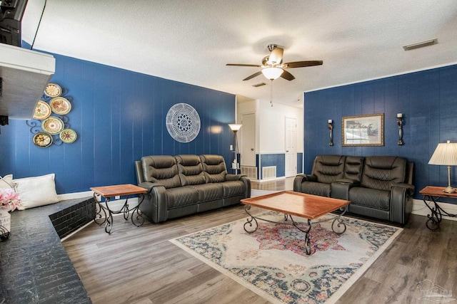 5945 Pamela Dr, Milton, FL 32570 - living area with ceiling fan, wood finished floors, a textured ceiling, and baseboards