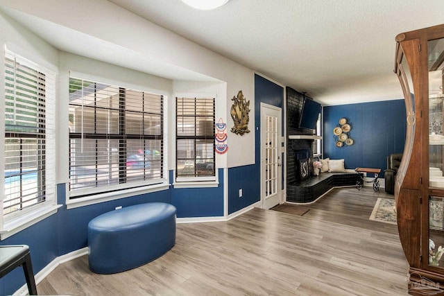 5945 Pamela Dr, Milton, FL 32570 - sitting room with baseboards, wood finished floors, plenty of natural light, and a textured ceiling