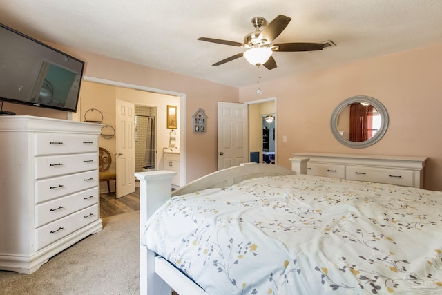 5945 Pamela Dr, Milton, FL 32570 - bedroom with ensuite bath, a ceiling fan, and light colored carpet