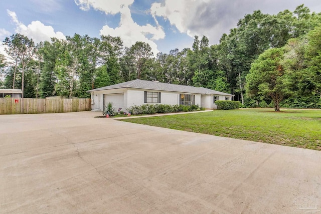 5945 Pamela Dr, Milton, FL 32570 - view of front facade with driveway, an attached garage, and view of wooded area