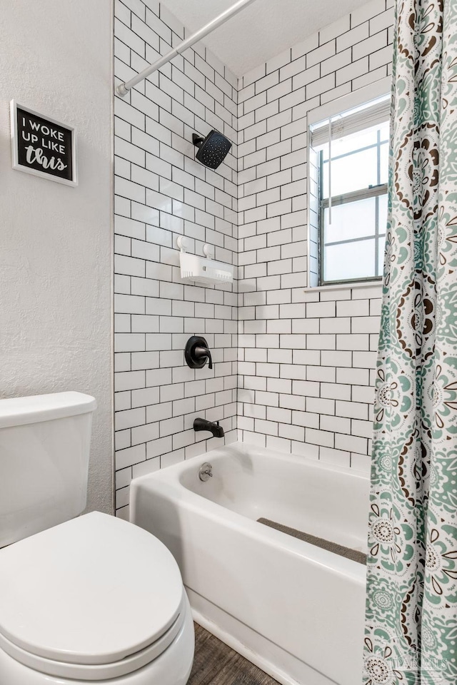 5945 Pamela Dr, Milton, FL 32570 - full bathroom featuring toilet, shower / tub combo, and wood finished floors