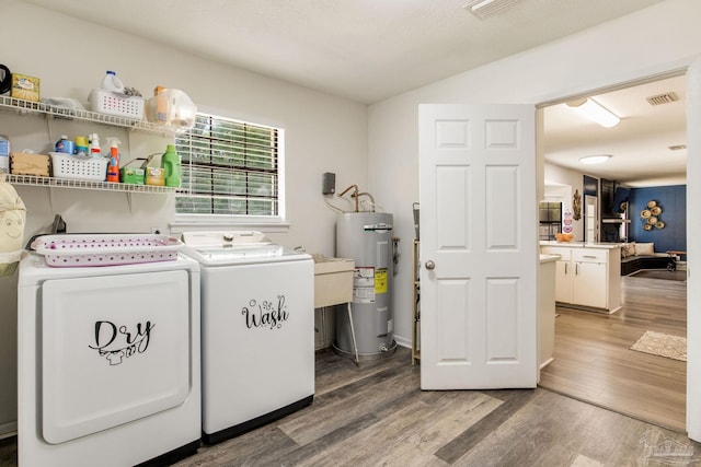 5945 Pamela Dr, Milton, FL 32570 - laundry area featuring electric water heater, washing machine and dryer, and wood finished floors