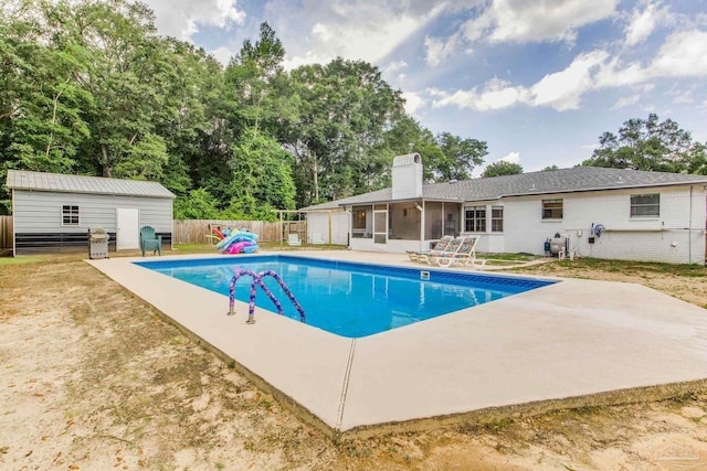 5945 Pamela Dr, Milton, FL 32570 - view of pool with a sunroom, a patio area, a fenced backyard, and an outdoor structure