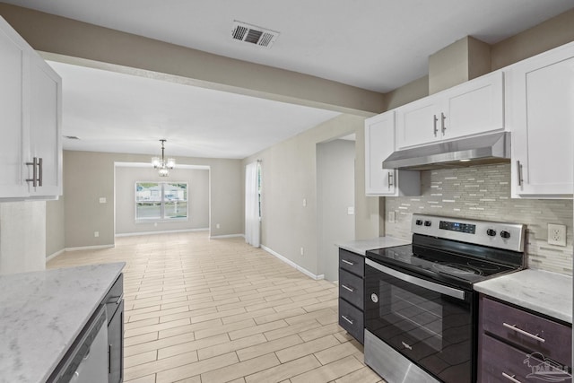 kitchen with appliances with stainless steel finishes, tasteful backsplash, decorative light fixtures, a notable chandelier, and white cabinets