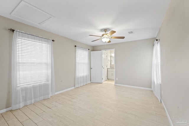 unfurnished room with light wood-type flooring and ceiling fan