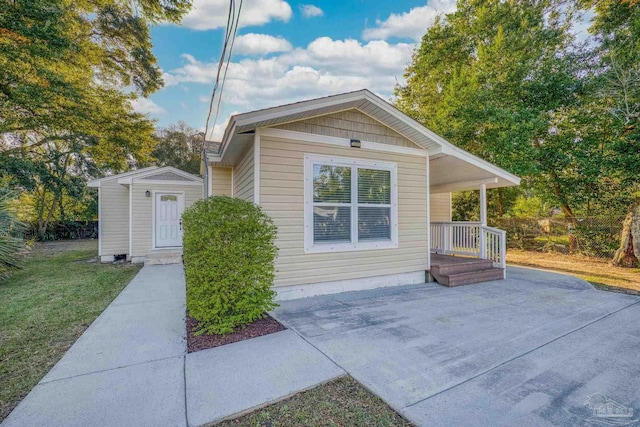 view of home's exterior featuring a lawn and a storage shed