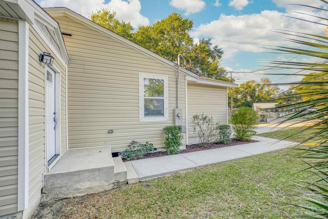 view of property exterior featuring a lawn