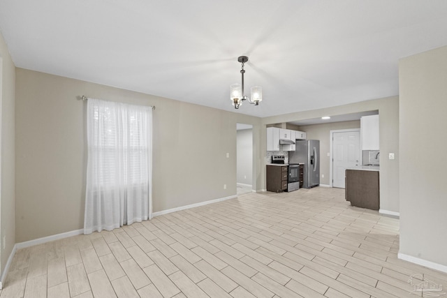 unfurnished living room with a notable chandelier