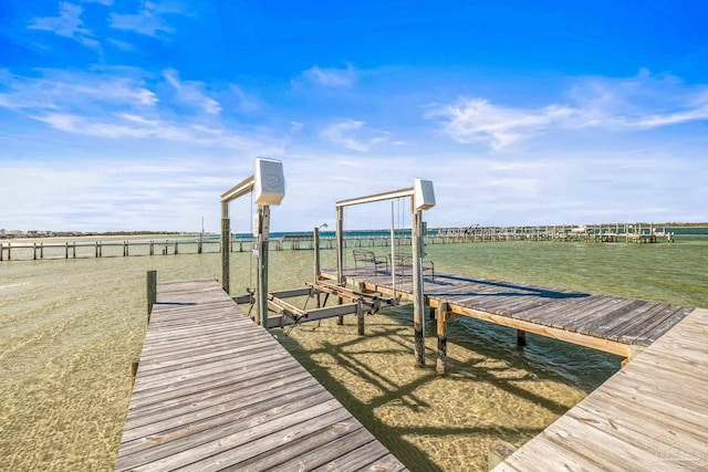 dock area with a water view and a rural view