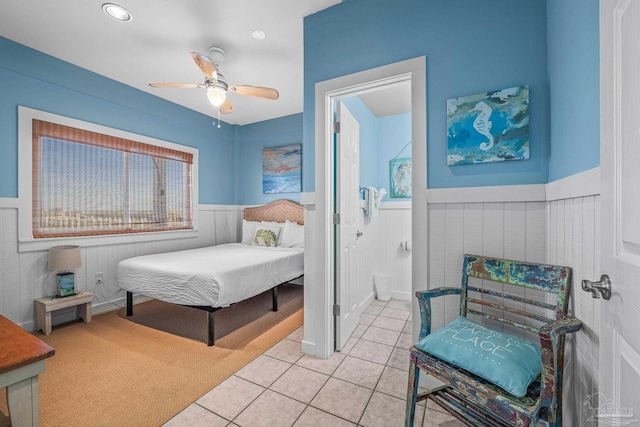 tiled bedroom with ceiling fan and connected bathroom