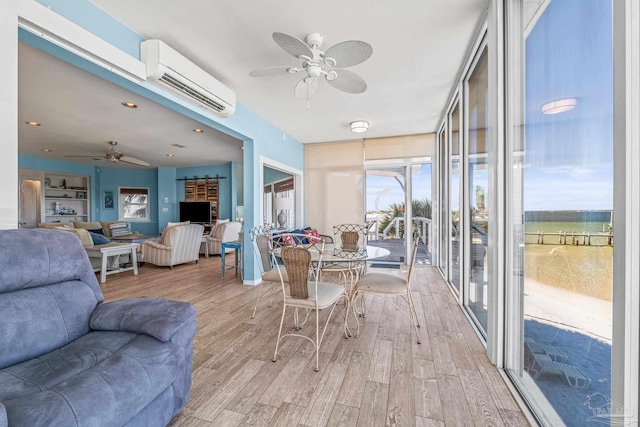 sunroom / solarium featuring an AC wall unit and ceiling fan