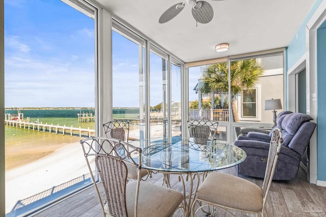 sunroom / solarium featuring plenty of natural light, a rural view, and ceiling fan