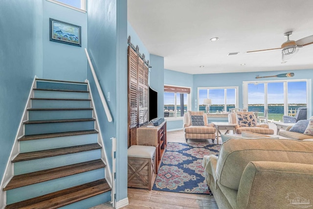 living room with hardwood / wood-style floors and ceiling fan