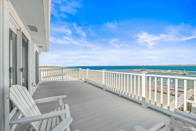 wooden terrace with a water view and a beach view