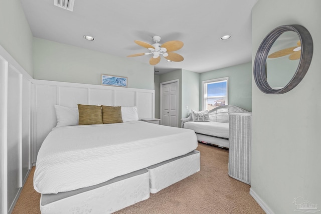 carpeted bedroom with a closet and ceiling fan