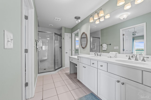 bathroom with vanity, a shower with shower door, and tile patterned floors