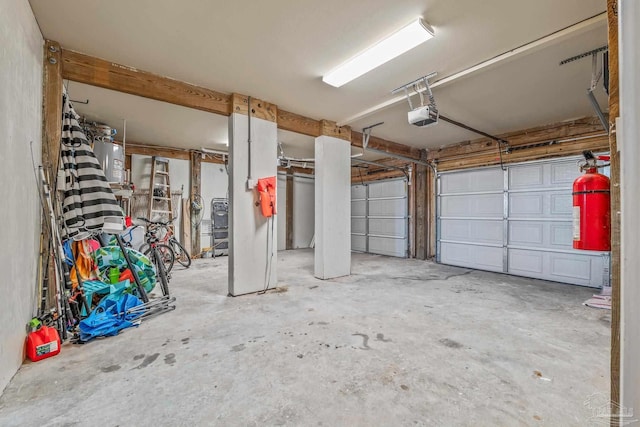 garage with a garage door opener and electric water heater