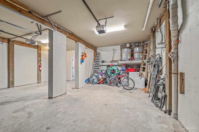 garage with a garage door opener and water heater