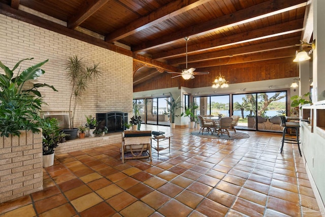 living room featuring a towering ceiling, ceiling fan, a brick fireplace, wooden ceiling, and beam ceiling