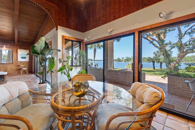 sunroom with wooden ceiling, a water view, and lofted ceiling with beams