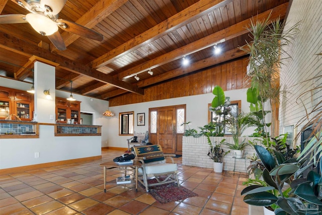 tiled living room featuring beam ceiling, ceiling fan, wood ceiling, and track lighting