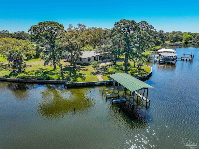 dock area featuring a lawn and a water view