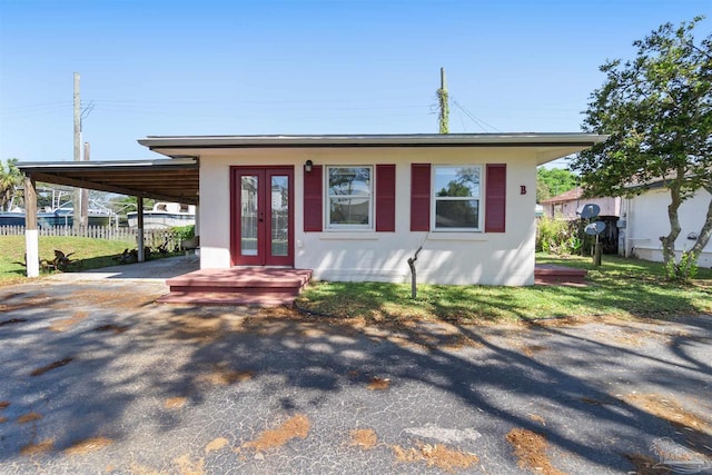 view of front facade featuring french doors and a carport