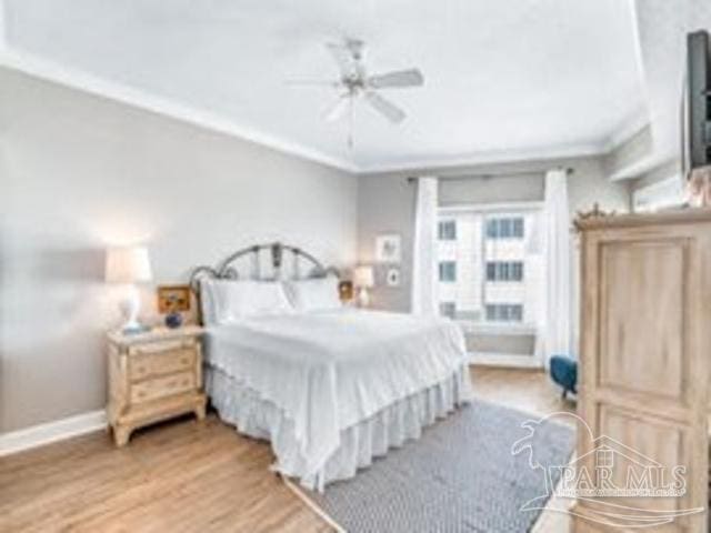 22984 Perdido Beach Blvd Unit B42, Orange Beach, AL 36561 - bedroom with ceiling fan, baseboards, crown molding, and wood finished floors