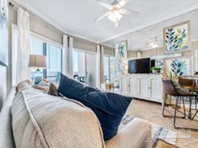 22984 Perdido Beach Blvd Unit B42, Orange Beach, AL 36561 - living area with wood finished floors, a ceiling fan, and ornamental molding