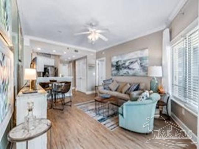 22984 Perdido Beach Blvd Unit B42, Orange Beach, AL 36561 - living area featuring crown molding, wood finished floors, a ceiling fan, and baseboards