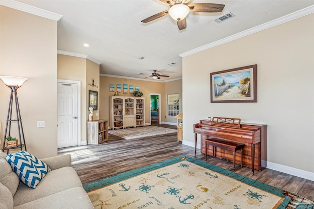 living room with dark hardwood / wood-style floors, ceiling fan, and crown molding