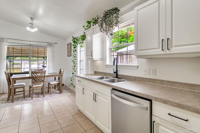 kitchen featuring vaulted ceiling, a wealth of natural light, dishwasher, and a sink