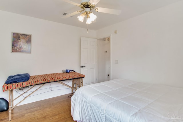 bedroom with visible vents, wood finished floors, and ceiling fan