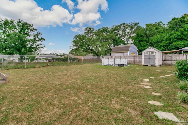 view of yard featuring a fenced backyard, a shed, and an outbuilding
