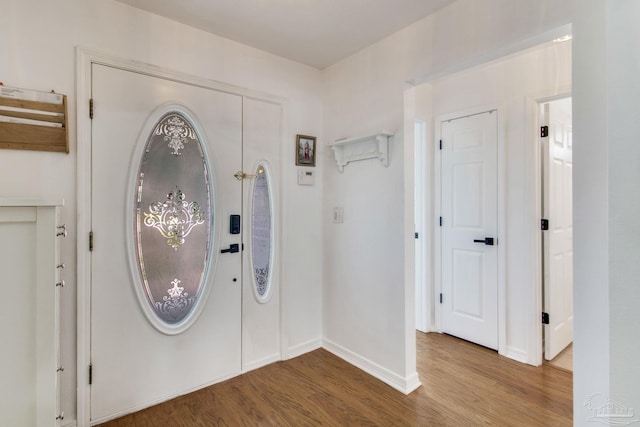 foyer entrance featuring wood finished floors and baseboards