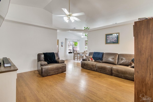 living room featuring baseboards, high vaulted ceiling, wood finished floors, and a ceiling fan