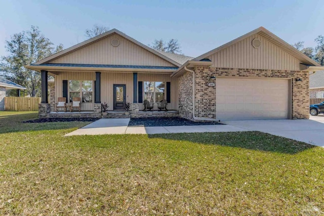 view of front of home with a front lawn, a porch, and a garage