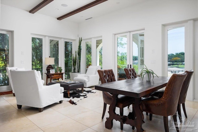 sunroom / solarium featuring beamed ceiling, plenty of natural light, and french doors