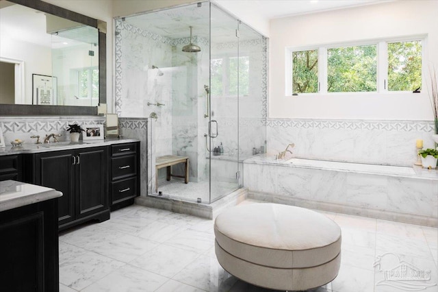 bathroom featuring vanity and independent shower and bath