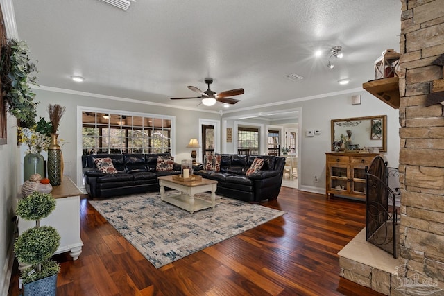 living room featuring ornamental molding, a textured ceiling, ceiling fan, and dark hardwood / wood-style flooring