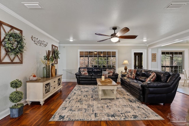 living room featuring ornamental molding, dark hardwood / wood-style floors, a textured ceiling, and ceiling fan